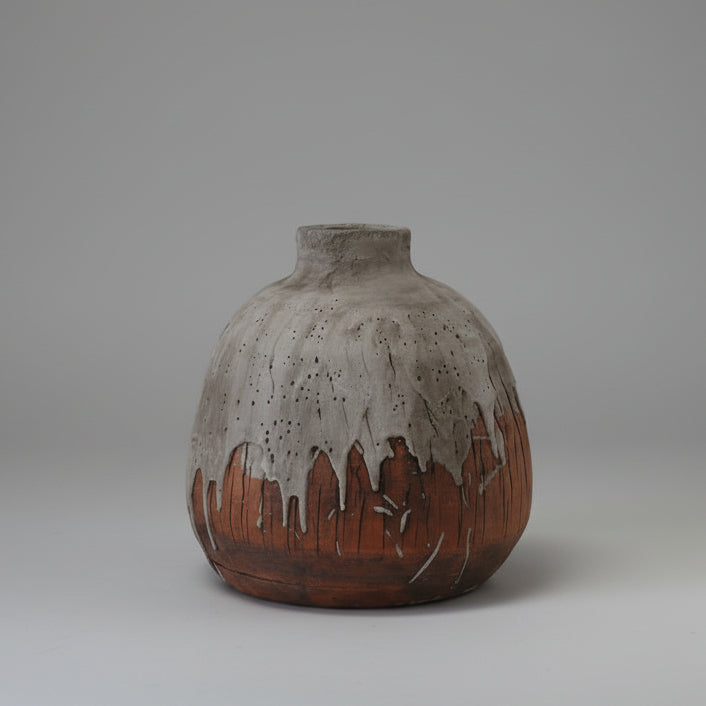 Ceramic vase with textured surface on a white background